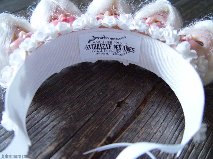 This piece is in all white, with 1940s doll heads and flowers.