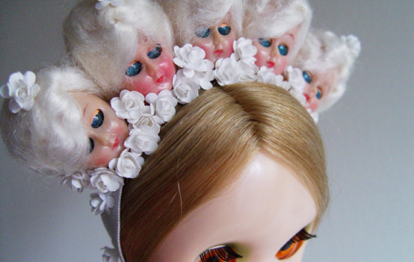 This piece is in all white, with 1940s doll heads and flowers.