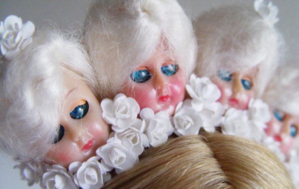 This piece is in all white, with 1940s doll heads and flowers.