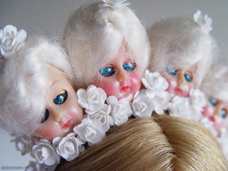 This piece is in all white, with 1940s doll heads and flowers.